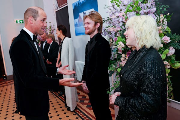Britain's Prince William, Duke of Cambridge (L) talks to US singer-songwriter Finneas O'Connell (C) ...