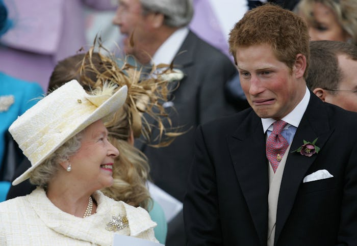 Britain's Queen Elizabeth II and Prince Harry share a joke as they watch Prince Charles and his brid...