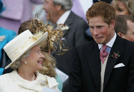 Britain's Queen Elizabeth II and Prince Harry share a joke as they watch Prince Charles and his brid...