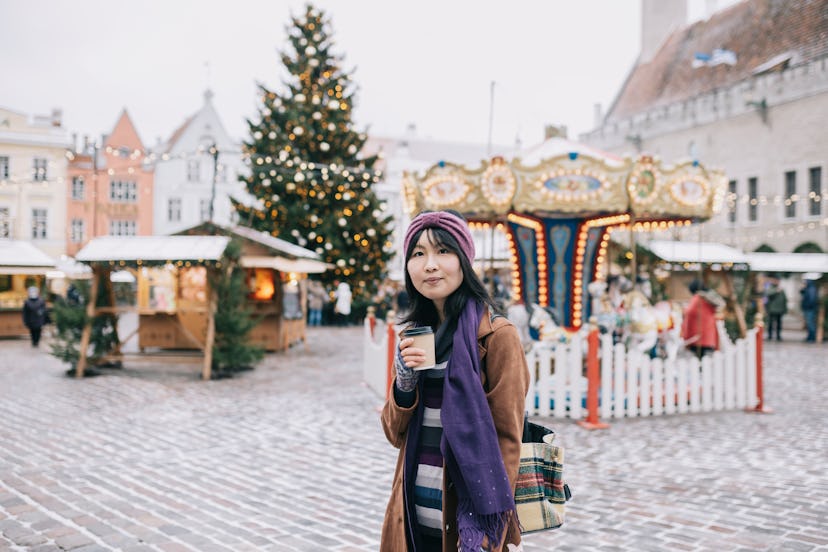 Young Chinese woman enjoying Christmas time in the city.