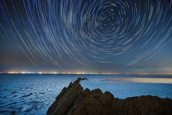 The night view of the coastline of Dalian, Liaoning Province, China. There are star tracks in the ni...