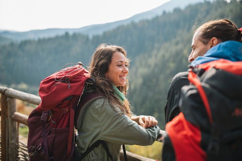 Couple taking a break from hiking and talking to one another