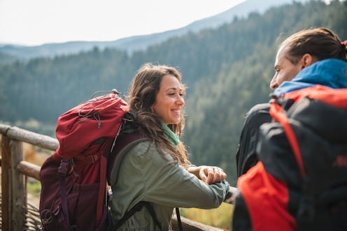 Couple taking a break from hiking and talking to one another