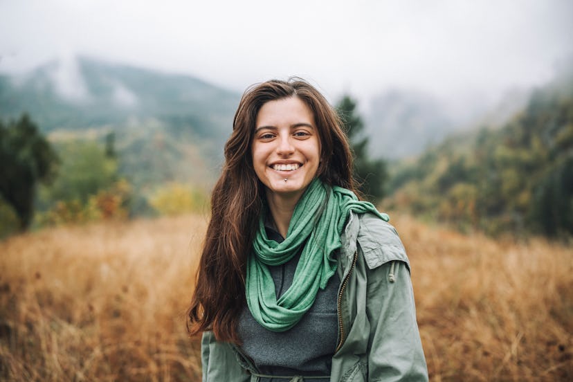 Young Woman Smiling And Looking At The Camera In Nature