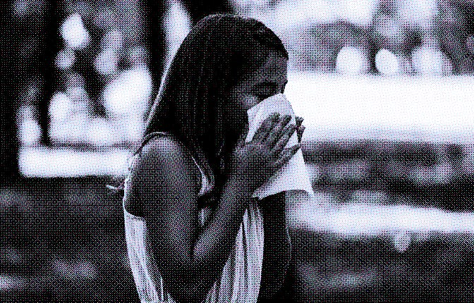 Photo of a Girl With Flu in Public Park Using Facial Tissues While Sneezing Due to Seasonal Flu or R...