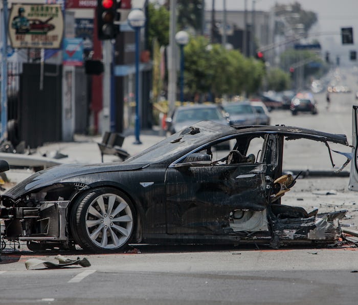 The Tesla's front half. A stolen Tesla automobile wrecked on La Brea Ave in LA after a police chase....