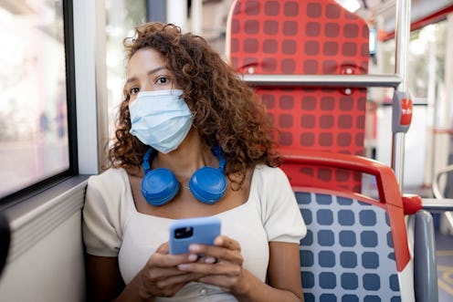 A woman wearing a mask texts a new friend while riding a bus. Here's how to get to know someone over...