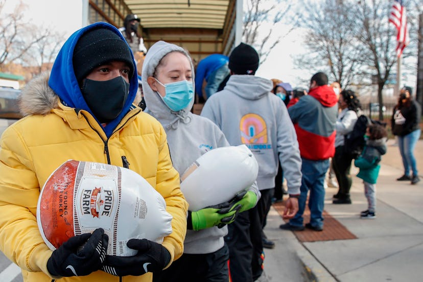 Volunteers distribute free turkeys to those in need on behalf of Chance The Rapper charitable founda...