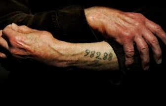 LONDON - DECEMBER 9:  Auschwitz survivor Mr. Leon Greenman, prison number 98288, displays his number...