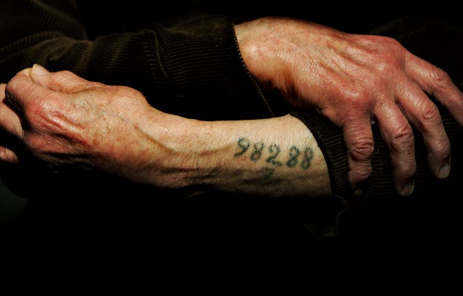 LONDON - DECEMBER 9: Auschwitz survivor Mr. Leon Greenman, prison number 98288, displays his number...