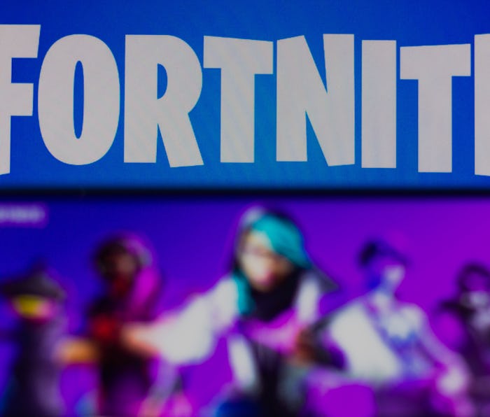 BRAZIL - 2021/03/30: In this photo illustration the Fortnite logo is seen on a smartphone and a pc s...