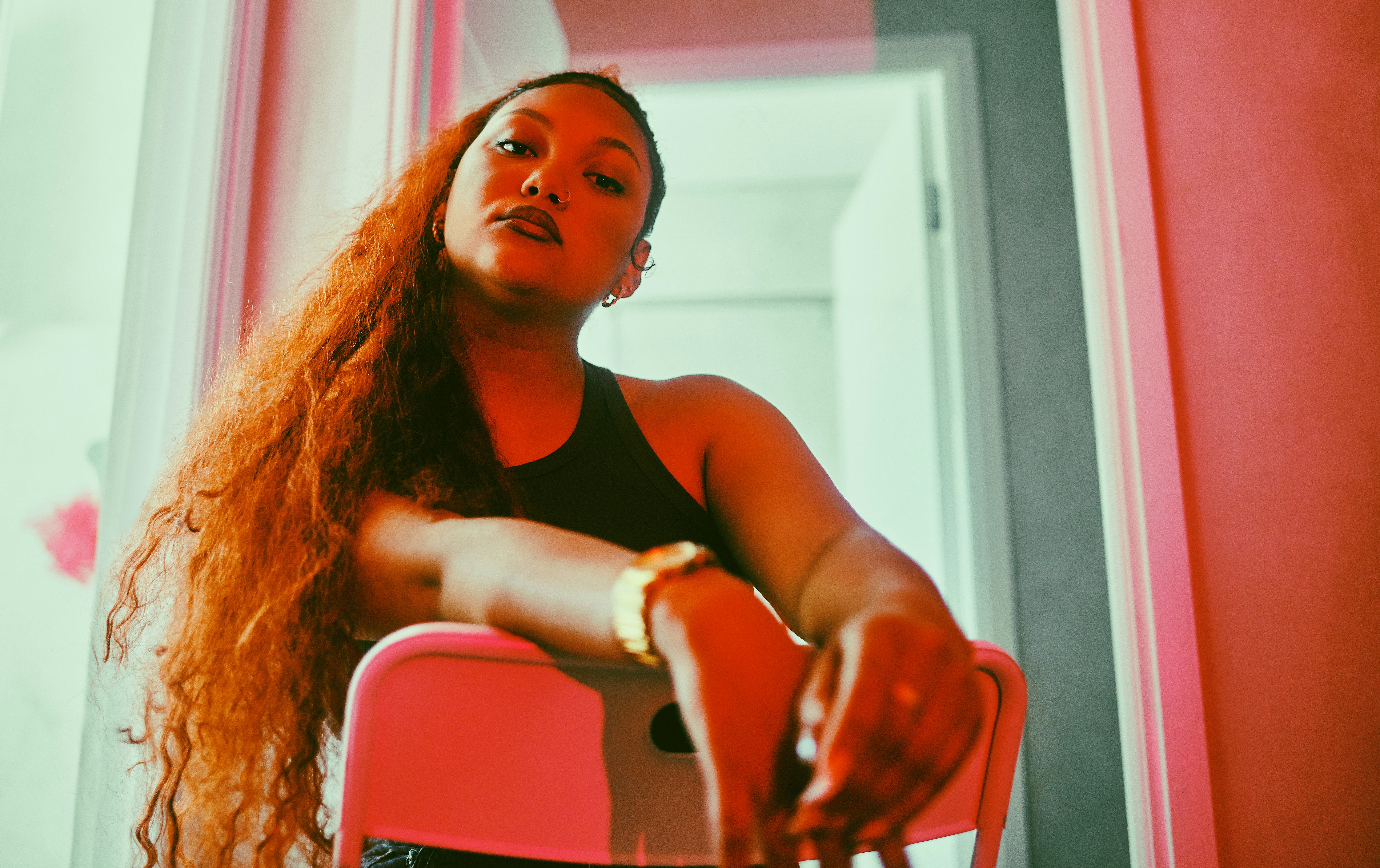 Shot of a fashionable young woman posing under red lighting