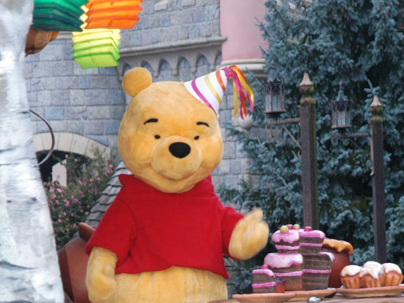 Winnie the Pooh in the "Christmas Parade" at Disneyland Park wears a party hat similar to him celebr...