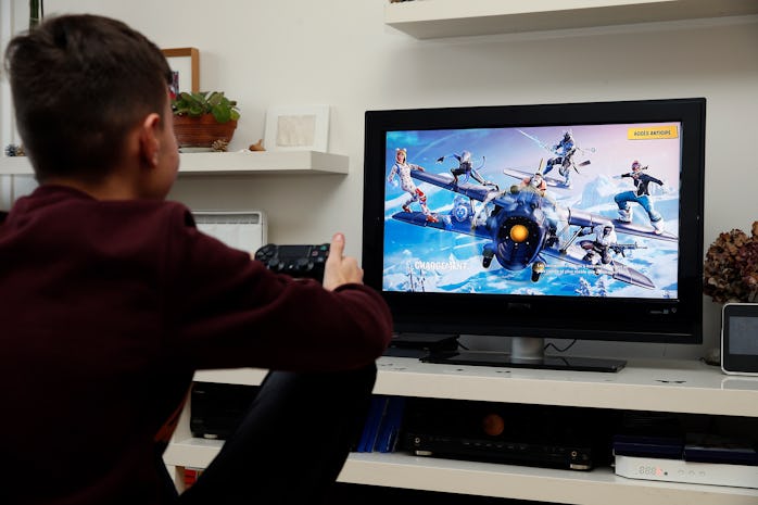 PARIS, FRANCE - DECEMBER 19: In this photo illustration a gamer plays the video game 'Fortnite Battl...