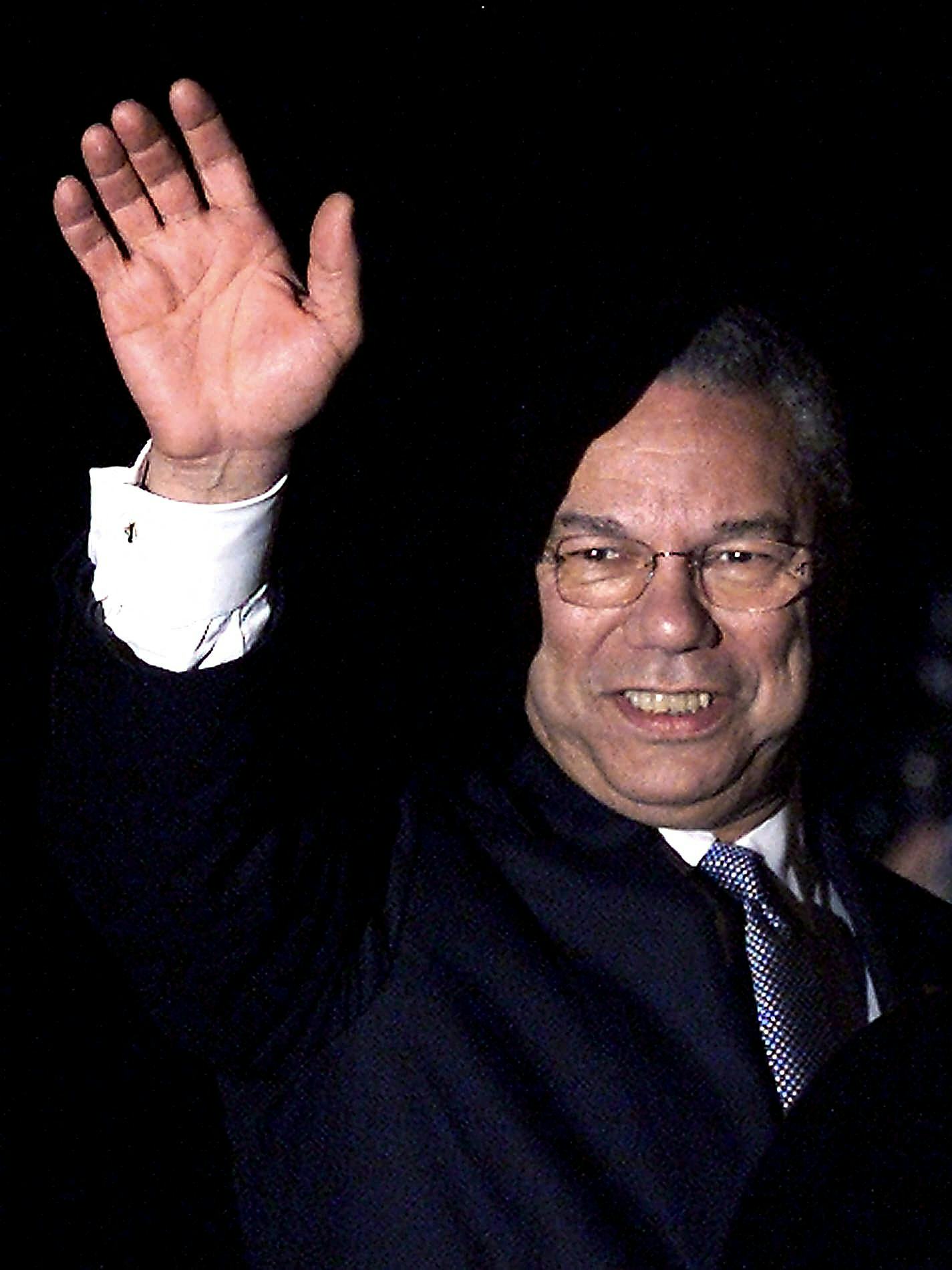 US Secretary of State Colin Powell waves to photographers shortly after arriving at the Royal Malays...