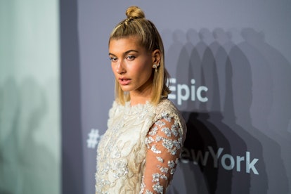 Hailey Baldwin attends the 2018 amfAR Gala New York wearing her hair in a ’90s-style half-up topkno...
