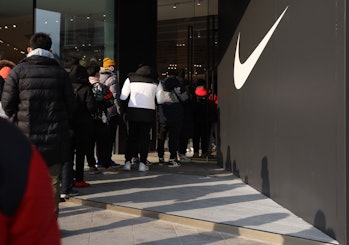 BEIJING, CHINA - JANUARY 20: Customers line up to enter a new Nike flagship store on the opening day...