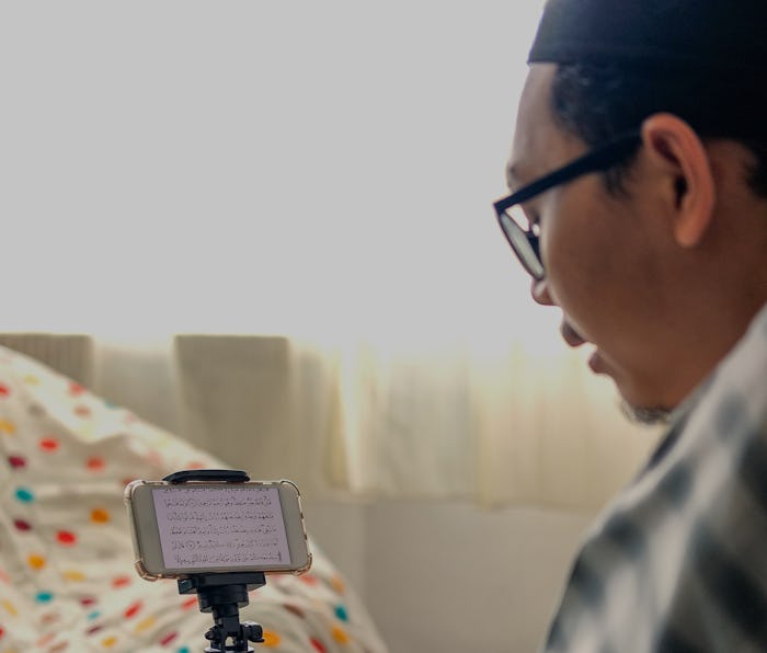 Muslim family using mobile at home during ramadhan