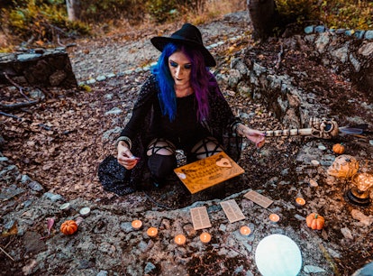 Young witch, fortune teller reads Tarot cards.
