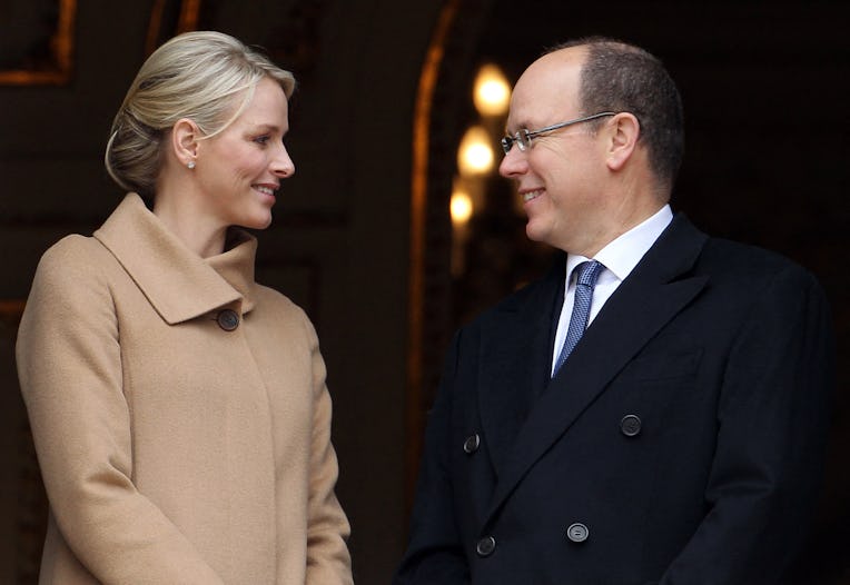 Prince Albert II of Monaco (R) looks at his wife, Princess Charlene, as they appear on a balcony dur...