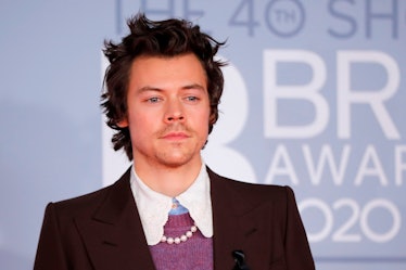 British singer-songwriter Harry Styles poses on the red carpet on arrival for the BRIT Awards 2020 i...