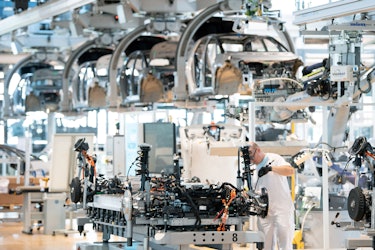 08 June 2021, Saxony, Dresden: A Volkswagen employee works on the body of a VW ID.3 during a press t...