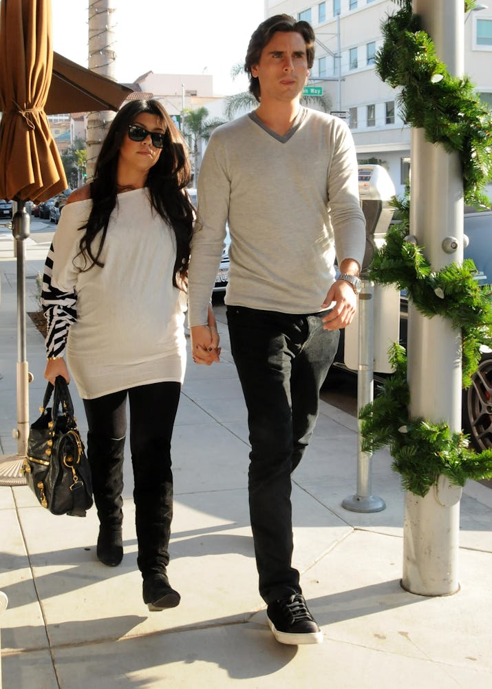 Kourtney Kardashian with Balenciaga bag walking with Scott Disick