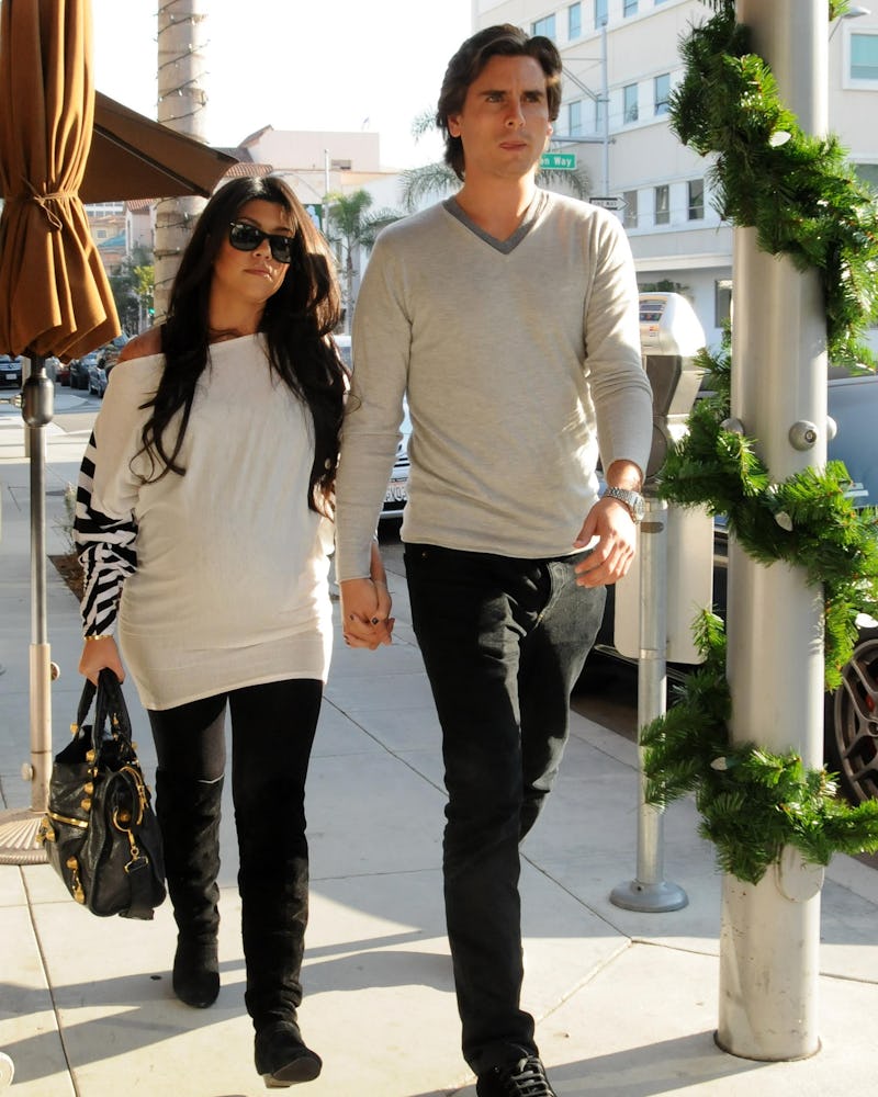 Kourtney Kardashian with Balenciaga bag walking with Scott Disick