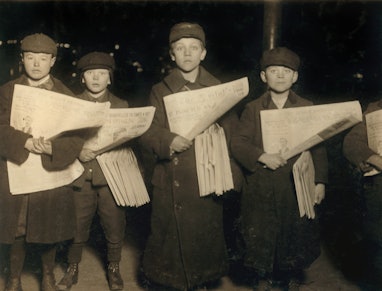 Four Young Newsboys Selling Newspapers at Hudson Tunnel Station, Jersey City, New Jersey, USA, circa...