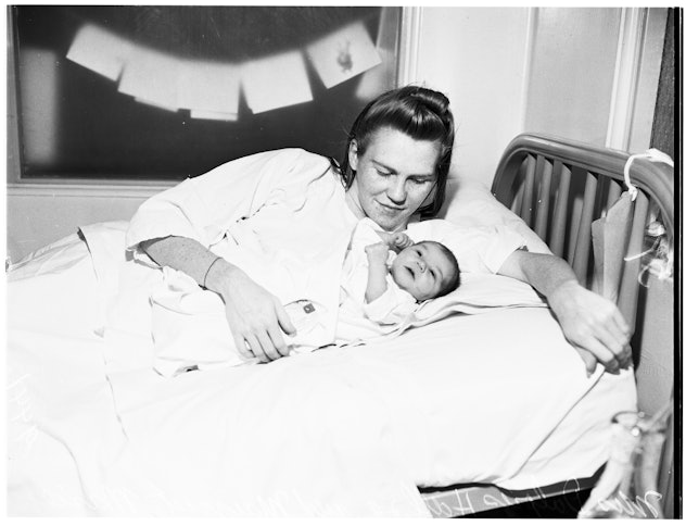 A mother gives birth just after midnight, Jan. 1, 1952.