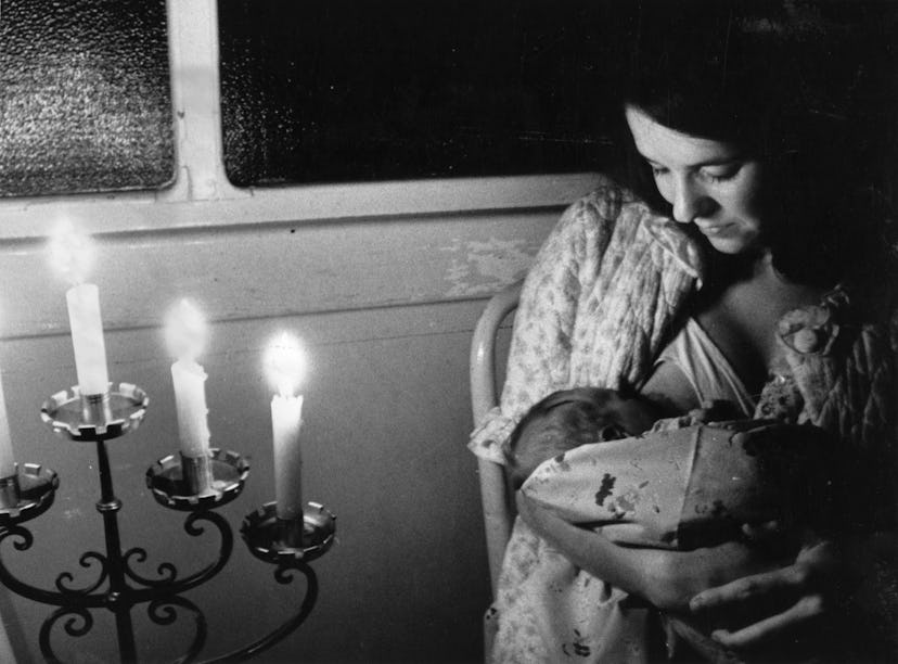 A mother nurses her baby during a blackout.