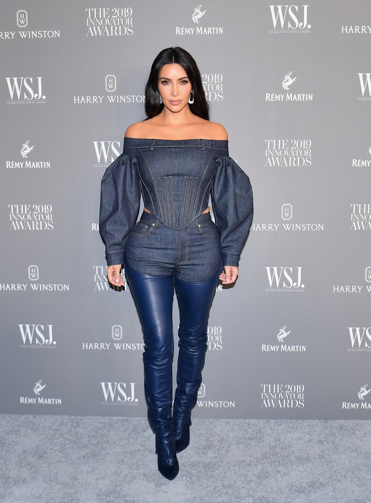 Kim Kardashian West at the WSJ Magazine 2019 Innovator Awards in a denim jumpsuit and blue metallic ...