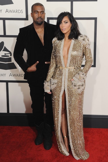 Kanye West in a black suit and Kim Kardashian in a golden gown at the 57th GRAMMY Awards 