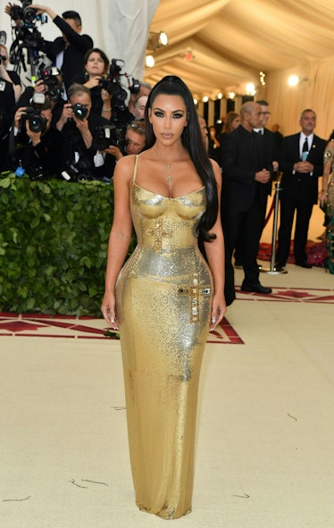 Kim Kardashian at the 2018 Met Gala in a metallic gold gown 