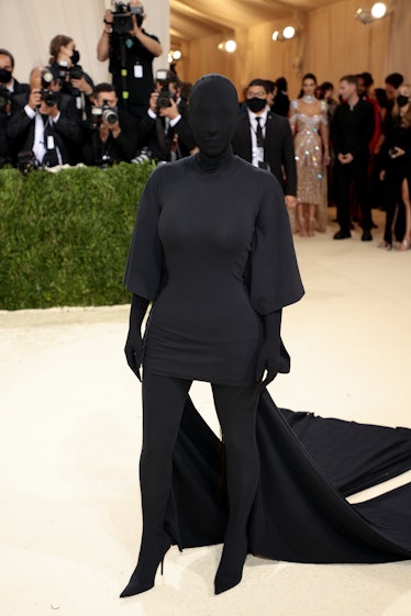 Kim Kardashian West at the Met Gala dressed in a black dress, boots and mask 
