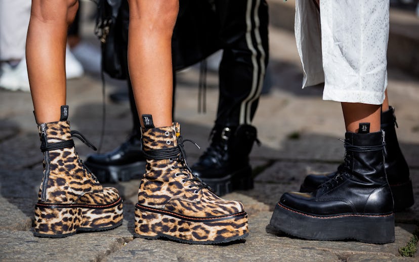 MILAN, ITALY - SEPTEMBER 26: A guest is seen wearing boots with animal print, black boots outside Dr...