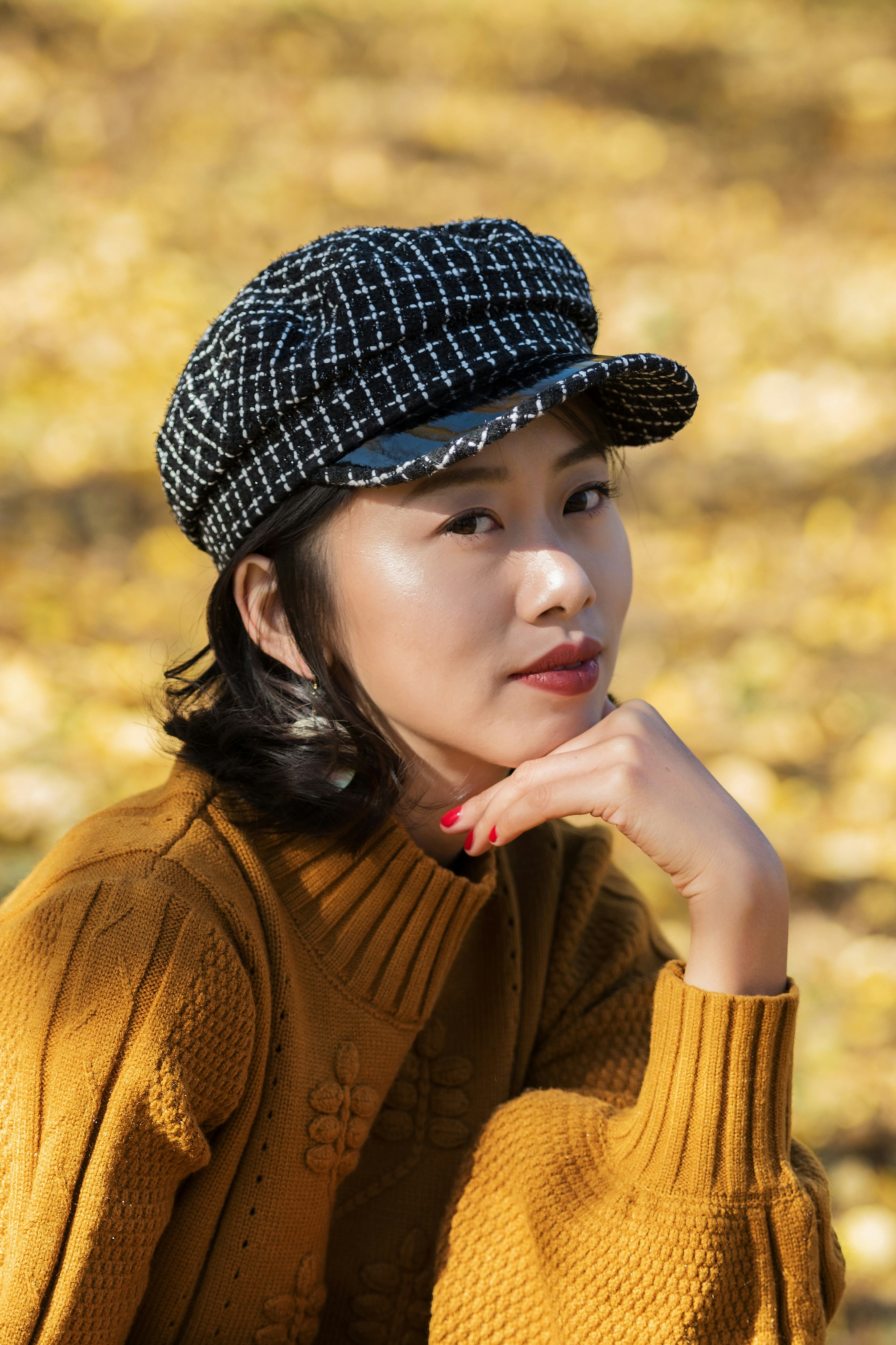 A woman in a hat looks at the camera. Scorpio season 2021 is passion-driven.