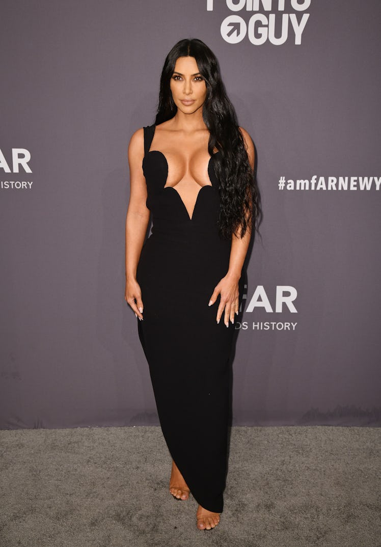  Kim Kardashian West at the amfAR New York Gala 2019 in a black gown with a plunging neckline 