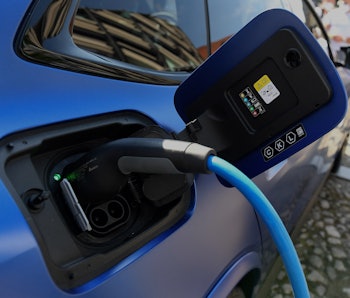 An electric car is charged at the stand of German car maker BMW at the Max-Joseph-Platz square in Mu...