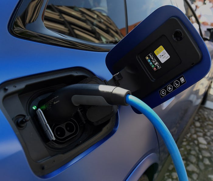 An electric car is charged at the stand of German car maker BMW at the Max-Joseph-Platz square in Mu...