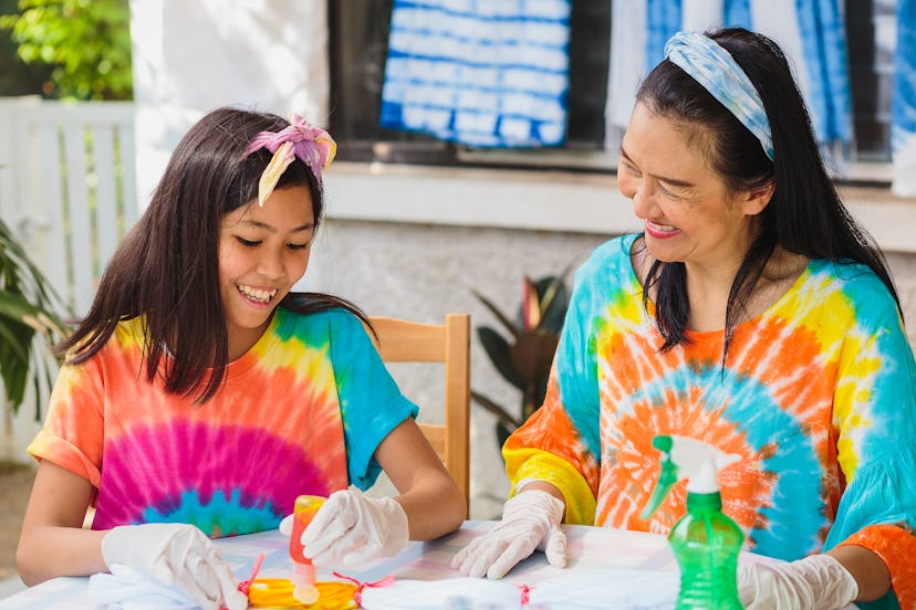 Asian mother and daughter enjoy making tie dye clothes at home