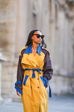 PARIS, FRANCE - OCTOBER 10: Emilie Joseph @in_fashionwetrust wears sunglasses, a blue, yellow and br...