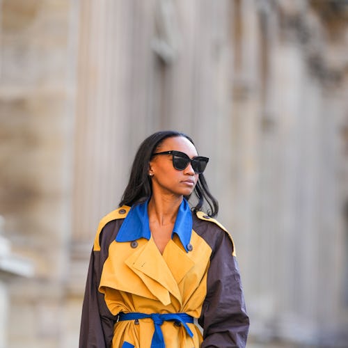 PARIS, FRANCE - OCTOBER 10: Emilie Joseph @in_fashionwetrust wears sunglasses, a blue, yellow and br...