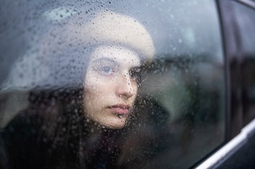 Sad Young Woman In A Car Looking Throung The Window On A Rainy Day