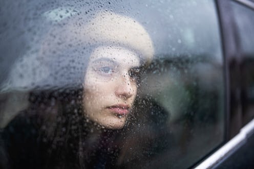 Sad Young Woman In A Car Looking Throung The Window On A Rainy Day
