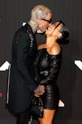 Travis Barker and Kourtney Kardashian are among the celebs with iconic photos of them kissing.