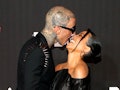 Travis Barker and Kourtney Kardashian are among the celebs with iconic photos of them kissing.