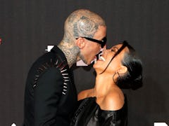 Travis Barker and Kourtney Kardashian are among the celebs with iconic photos of them kissing.