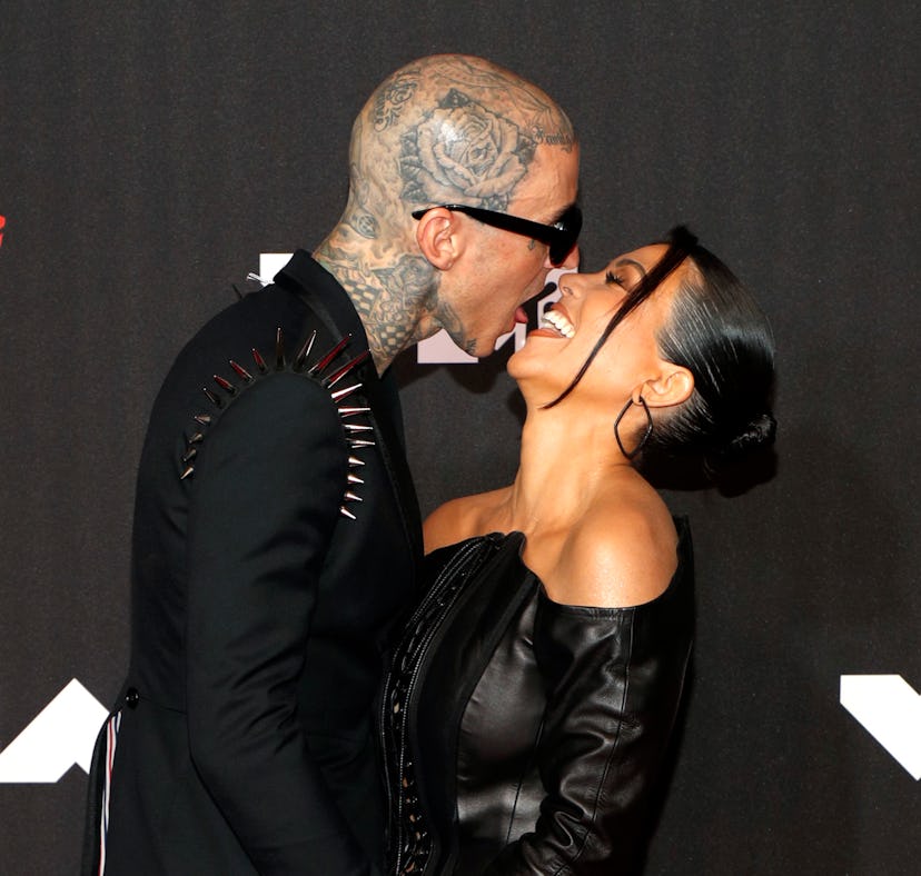 Travis Barker and Kourtney Kardashian are among the celebs with iconic photos of them kissing.