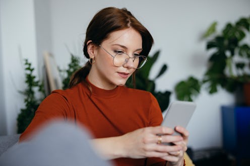 A woman looks at her Instagram to tell if someone deleted their Instagram or blocked her.